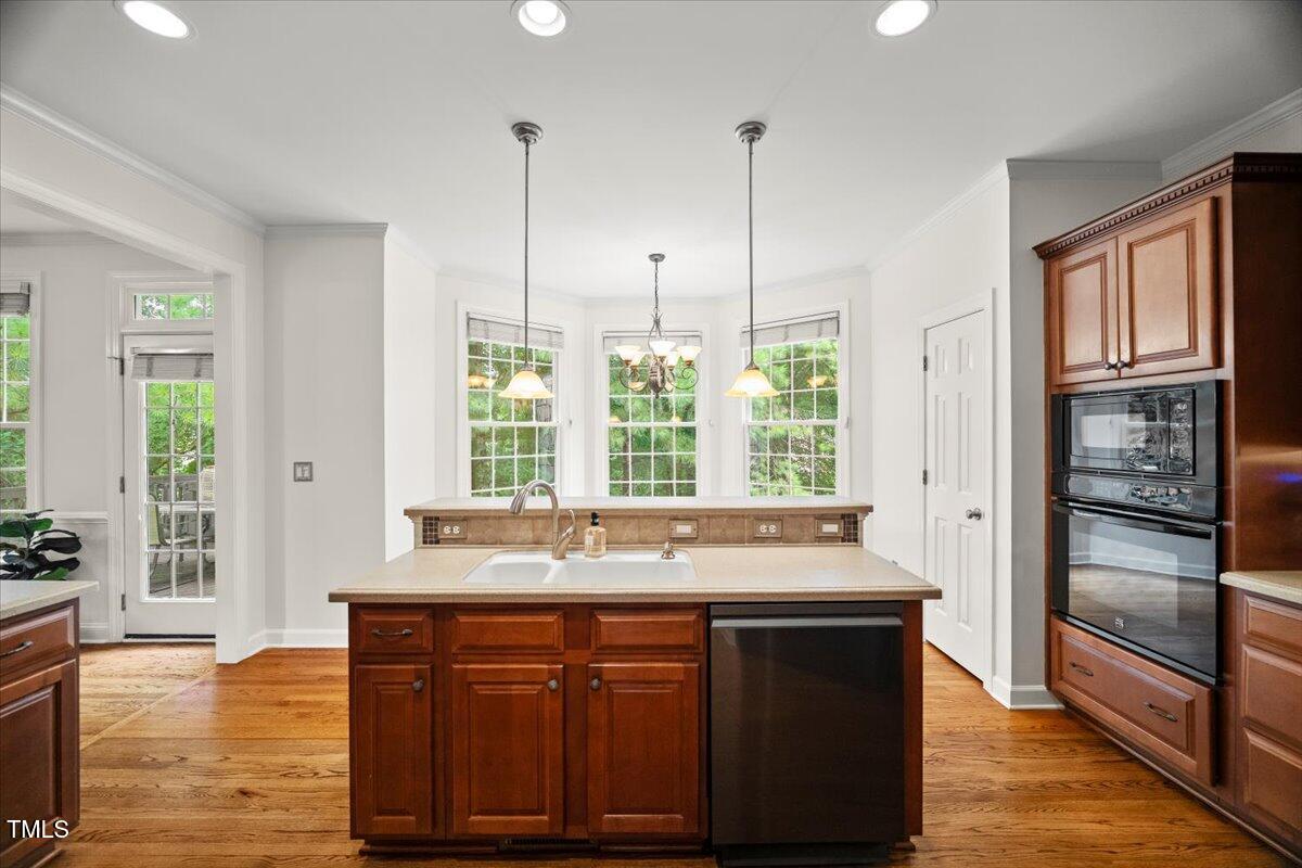 12204 Kaysmount Court Raleigh, NC 27614 - Photo 18 of 50 a kitchen with stainless steel appliances granite countertop a stove a sink and a refrigerator with wooden floor