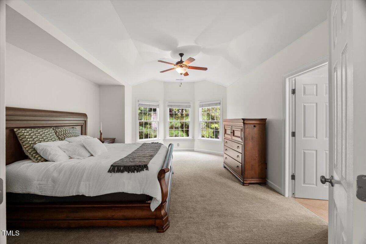12204 Kaysmount Court Raleigh, NC 27614 - Photo 25 of 50 a bedroom with a bed dresser and a large window