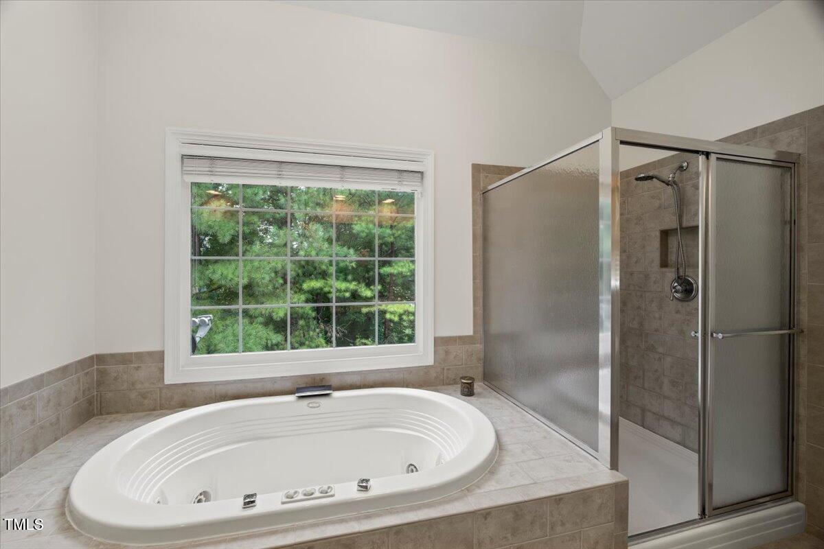 12204 Kaysmount Court Raleigh, NC 27614 - Photo 28 of 50 a bathroom with a bathtub and shower