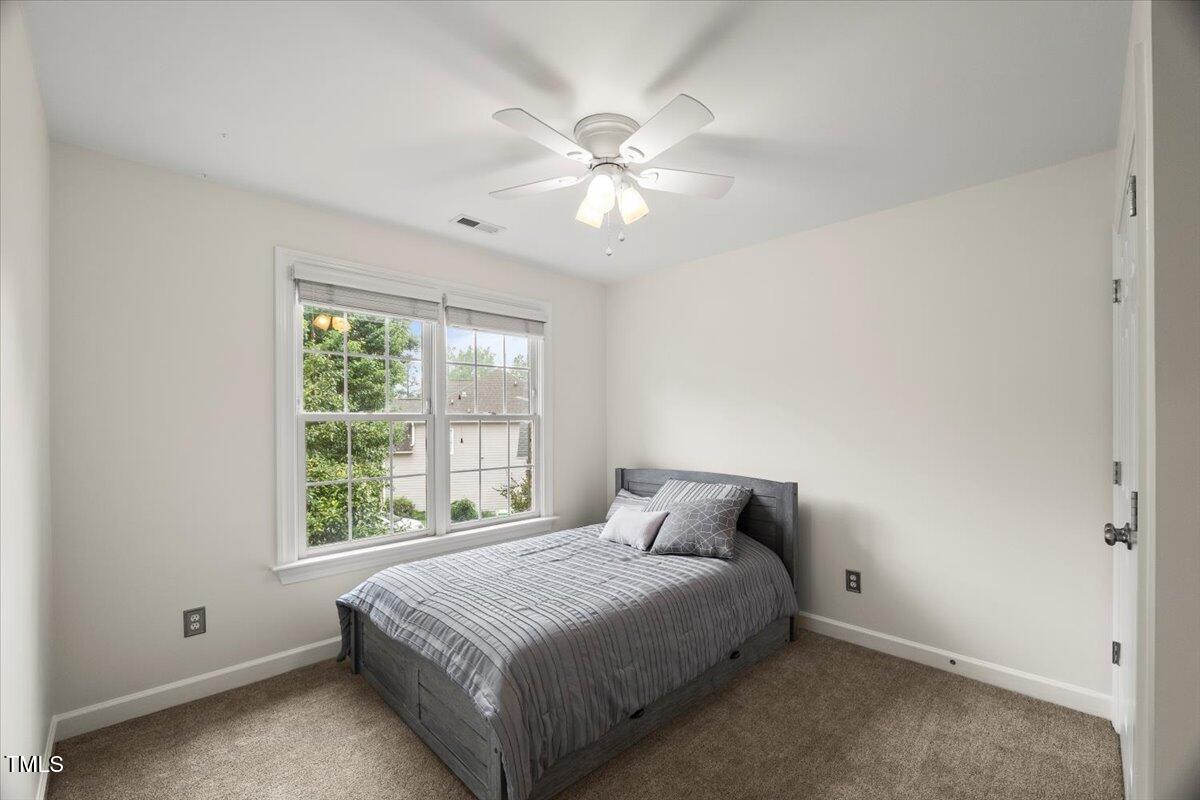 12204 Kaysmount Court Raleigh, NC 27614 - Photo 32 of 50 a bedroom with a bed and a window