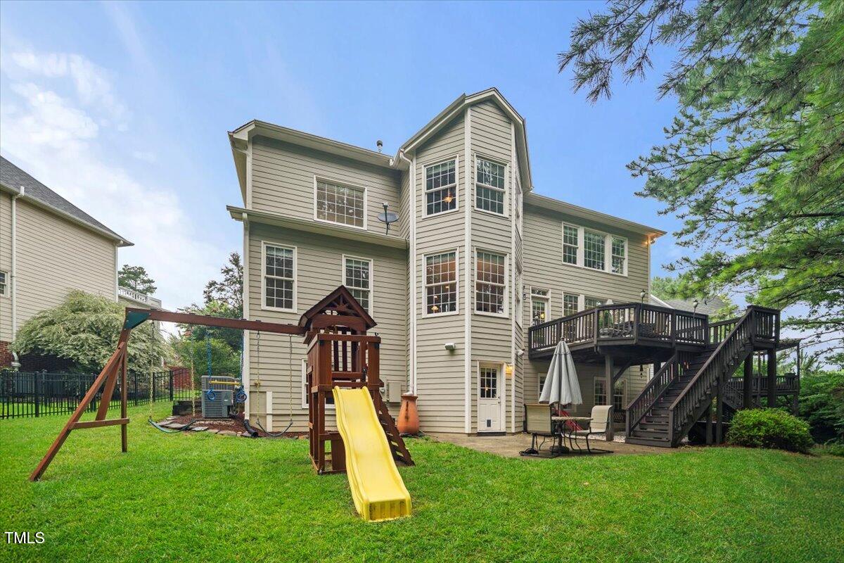 12204 Kaysmount Court Raleigh, NC 27614 - Photo 48 of 50 a view of a house with a yard and a slide