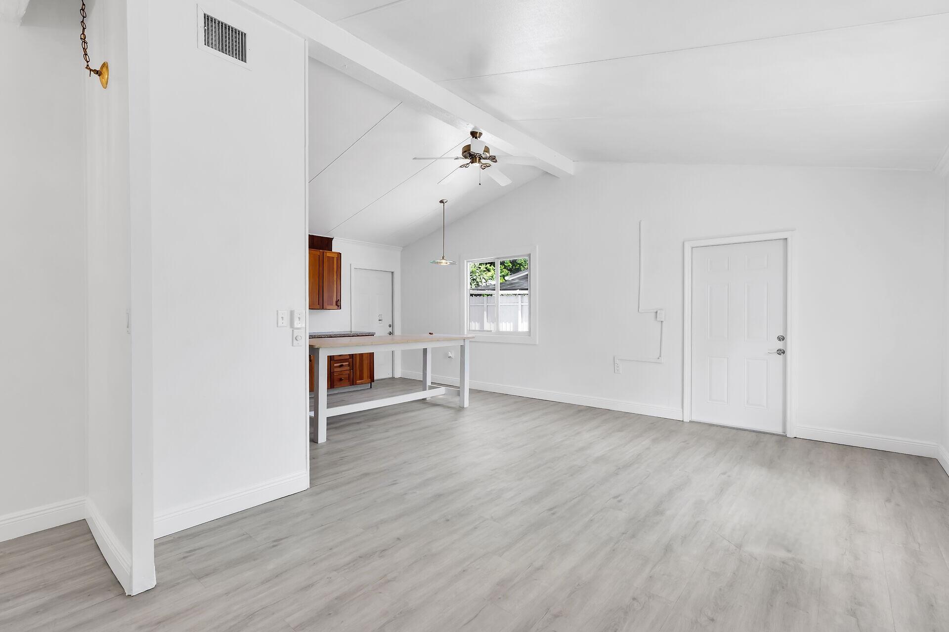 417 95th Street Marathon, FL 33050 - Photo 12 of 28 an empty room with wooden floor ceiling fan and windows