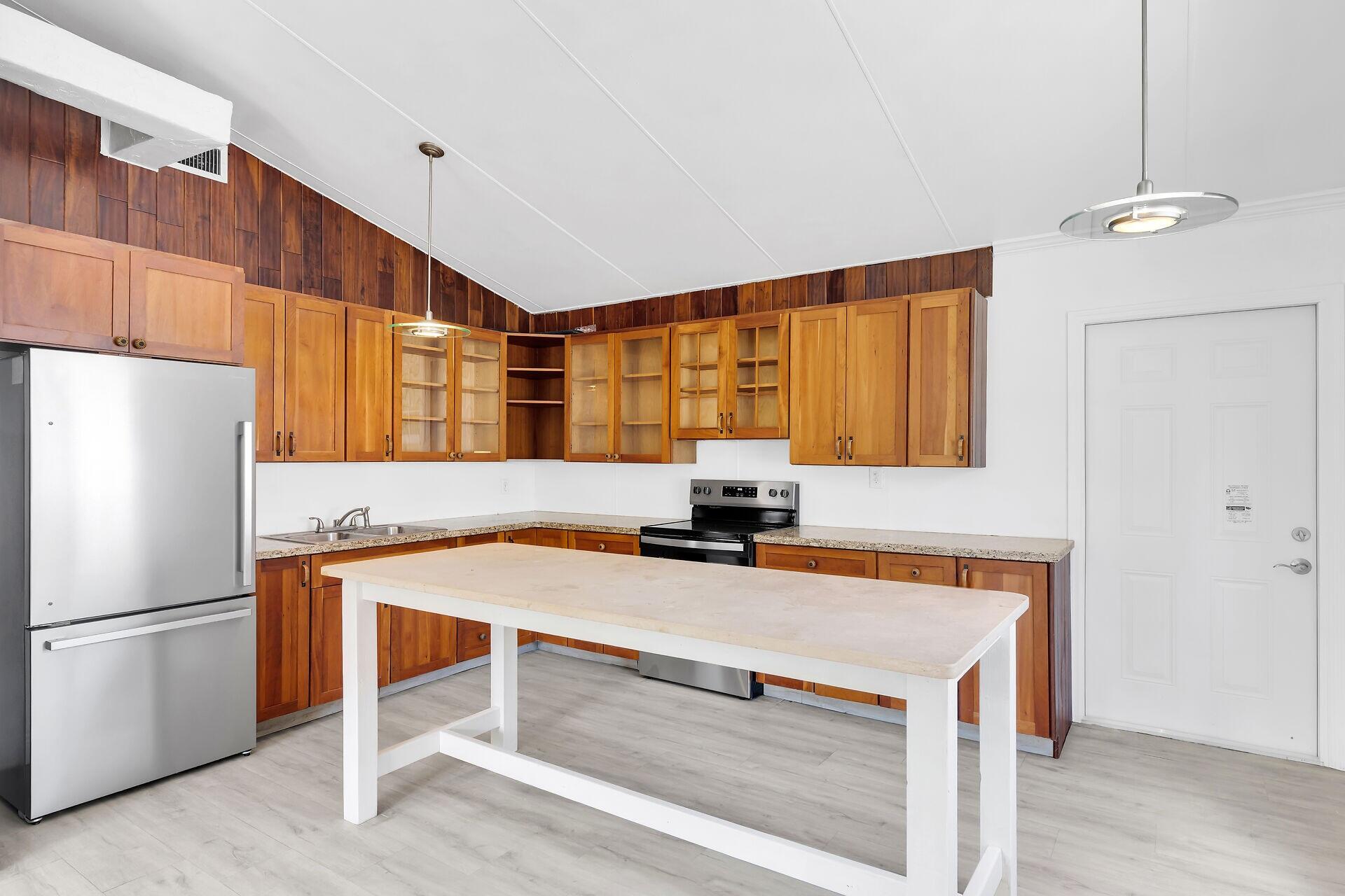 417 95th Street Marathon, FL 33050 - Photo 14 of 28 a kitchen with a refrigerator a sink and cabinets