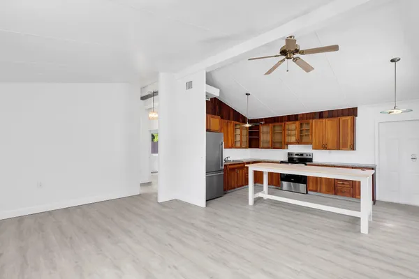 a view of a room with wooden floor and furniture