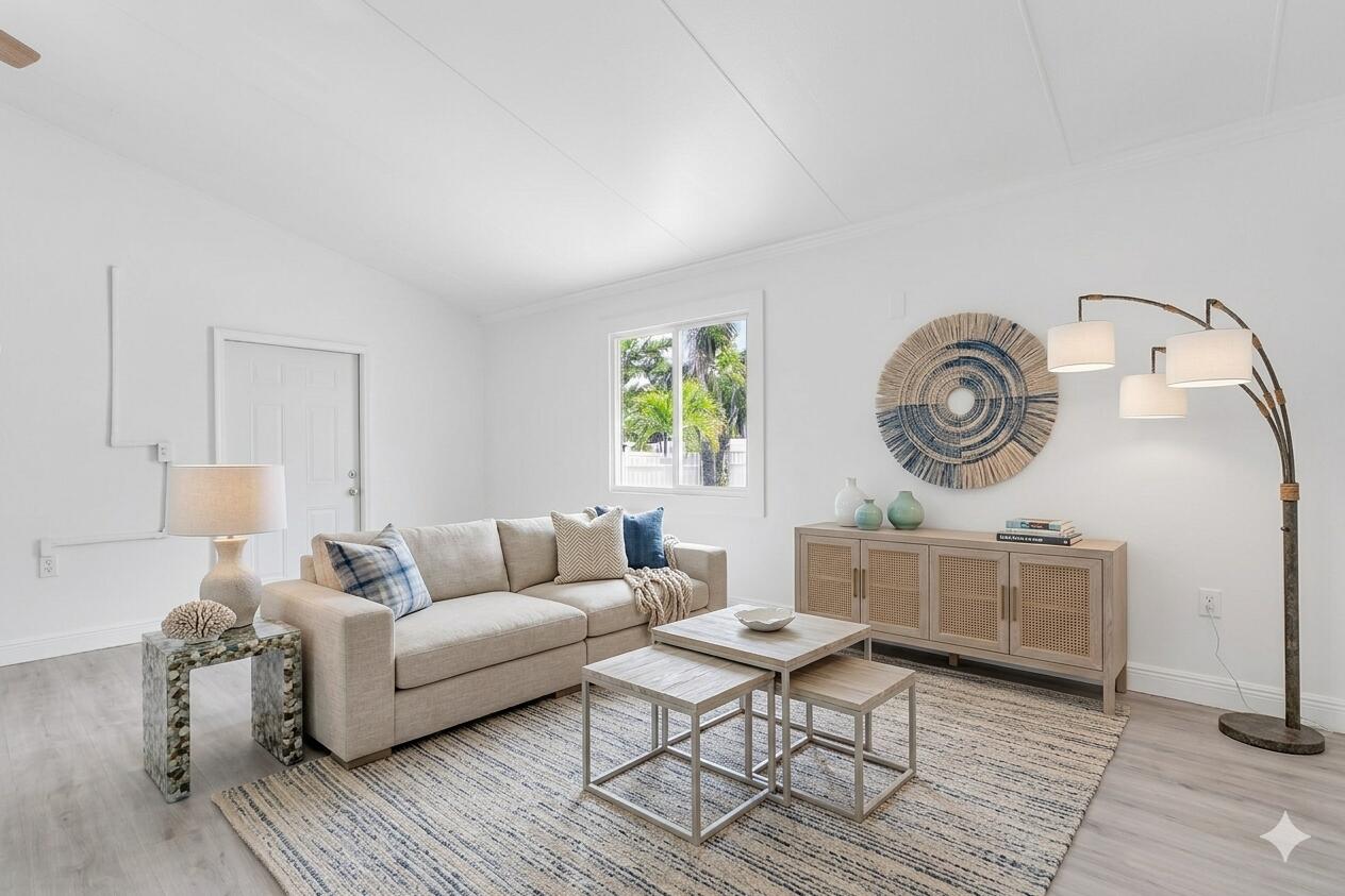 417 95th Street Marathon, FL 33050 - Photo 3 of 28 a living room with furniture a clock on wall and a window