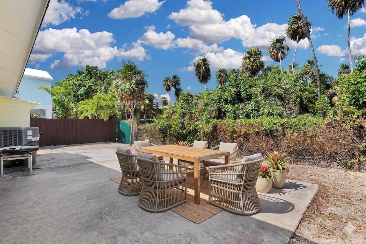 417 95th Street Marathon, FL 33050 - Photo 8 of 28 a view of a patio with table and chairs and potted plants