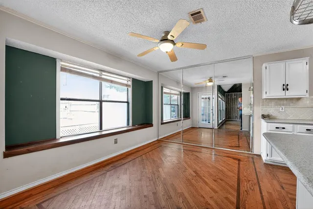 a kitchen with granite countertop a stove and a wooden floors