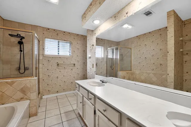 a spacious bathroom with a granite countertop sink a toilet and shower