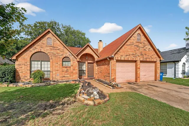 a view of a house with yard and sitting area
