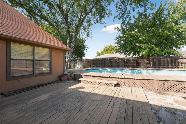a wooden bench sitting in front of a house