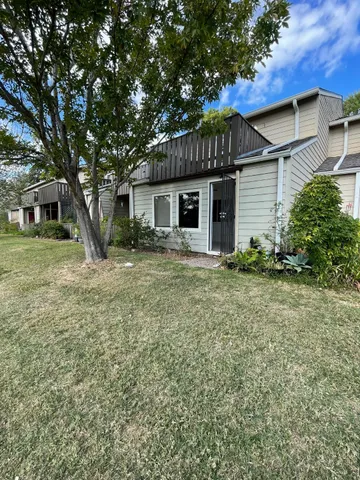 a front view of house with yard and trees