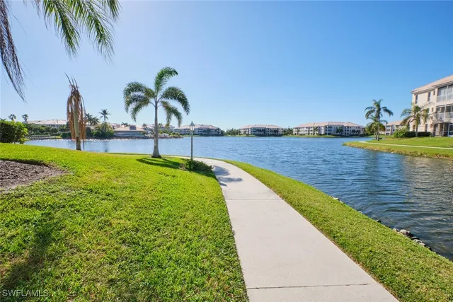 an aerial view of small house with a lake view