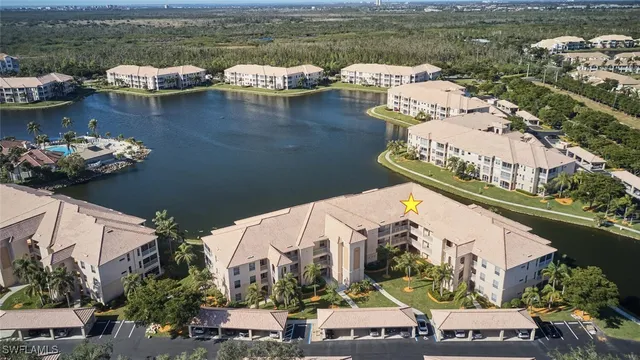 an aerial view of a house with a lake view
