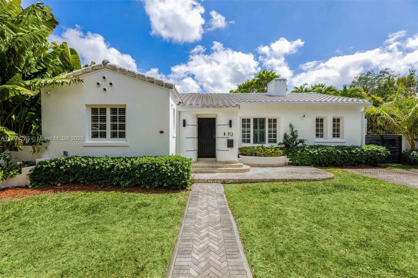 712 Northeast 72nd Street Miami, FL 33138 - Photo 1 of 35 a front view of a house with a yard