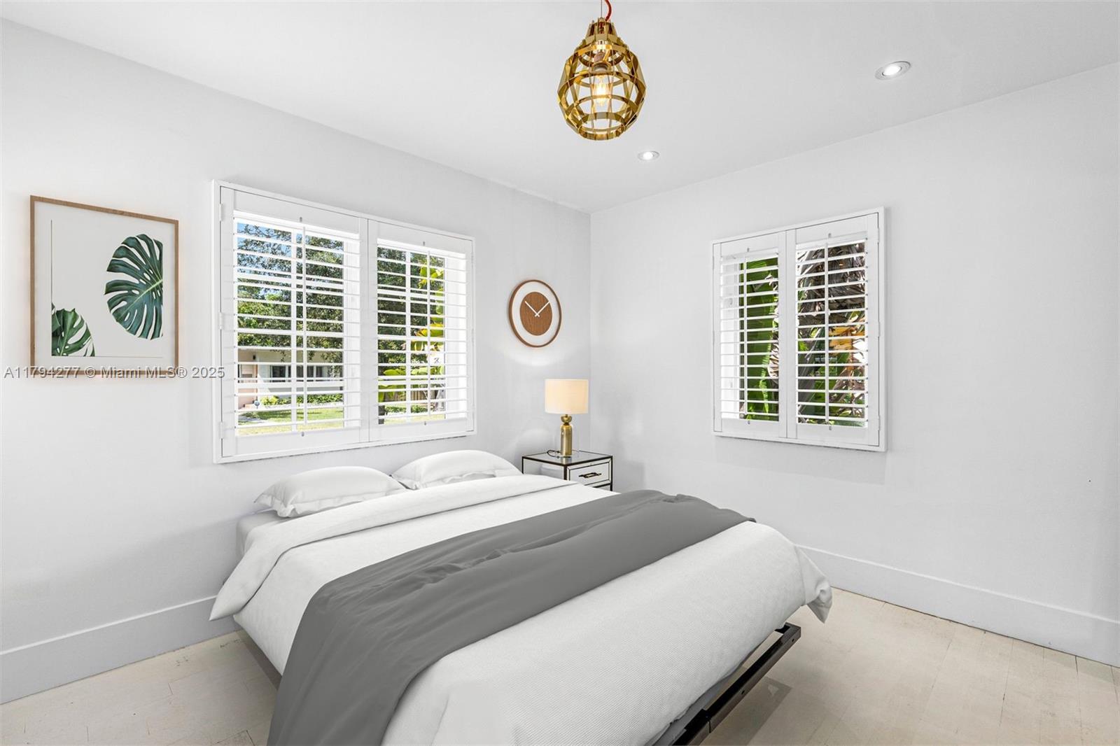 712 Northeast 72nd Street Miami, FL 33138 - Photo 12 of 35 a bedroom with a bed and a window