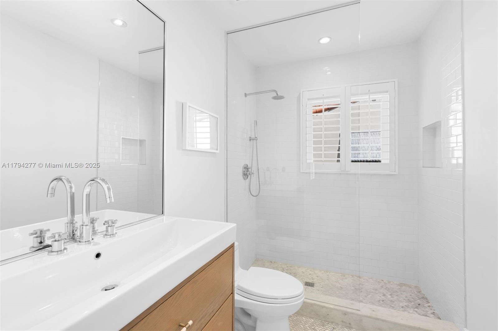 712 Northeast 72nd Street Miami, FL 33138 - Photo 13 of 35 a bathroom with a sink a toilet and shower