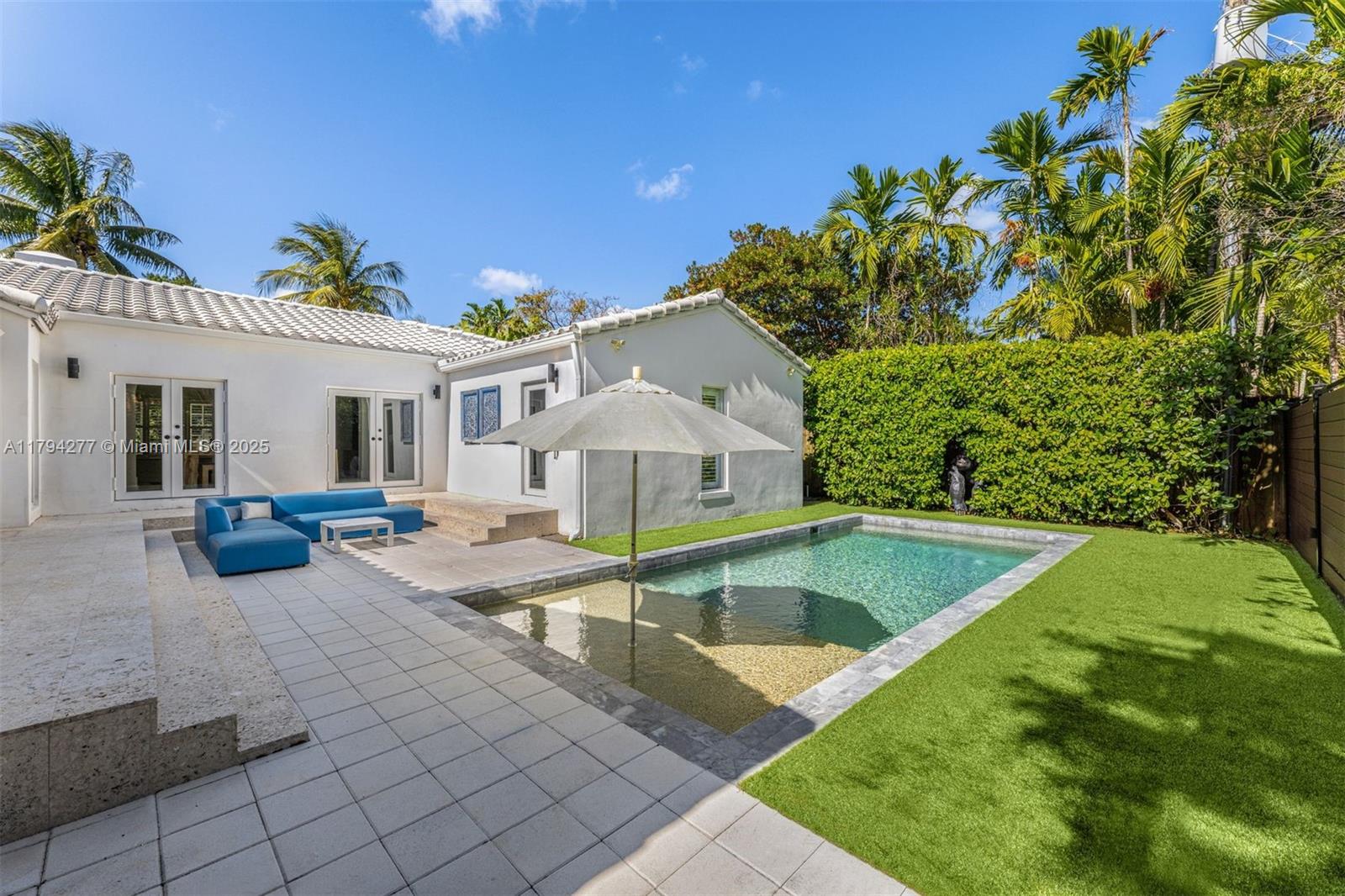 712 Northeast 72nd Street Miami, FL 33138 - Photo 14 of 35 a view of a house with swimming pool and sitting area