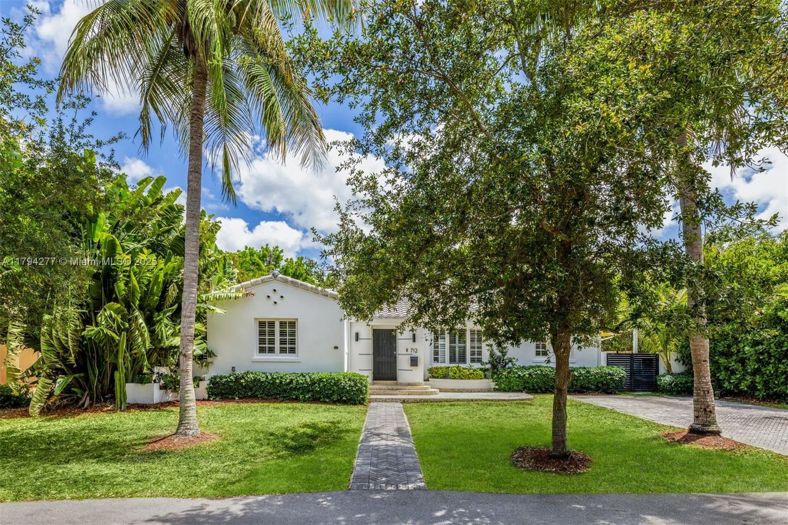 712 Northeast 72nd Street Miami, FL 33138 - Photo 17 of 35 a front view of a house with a yard and tree