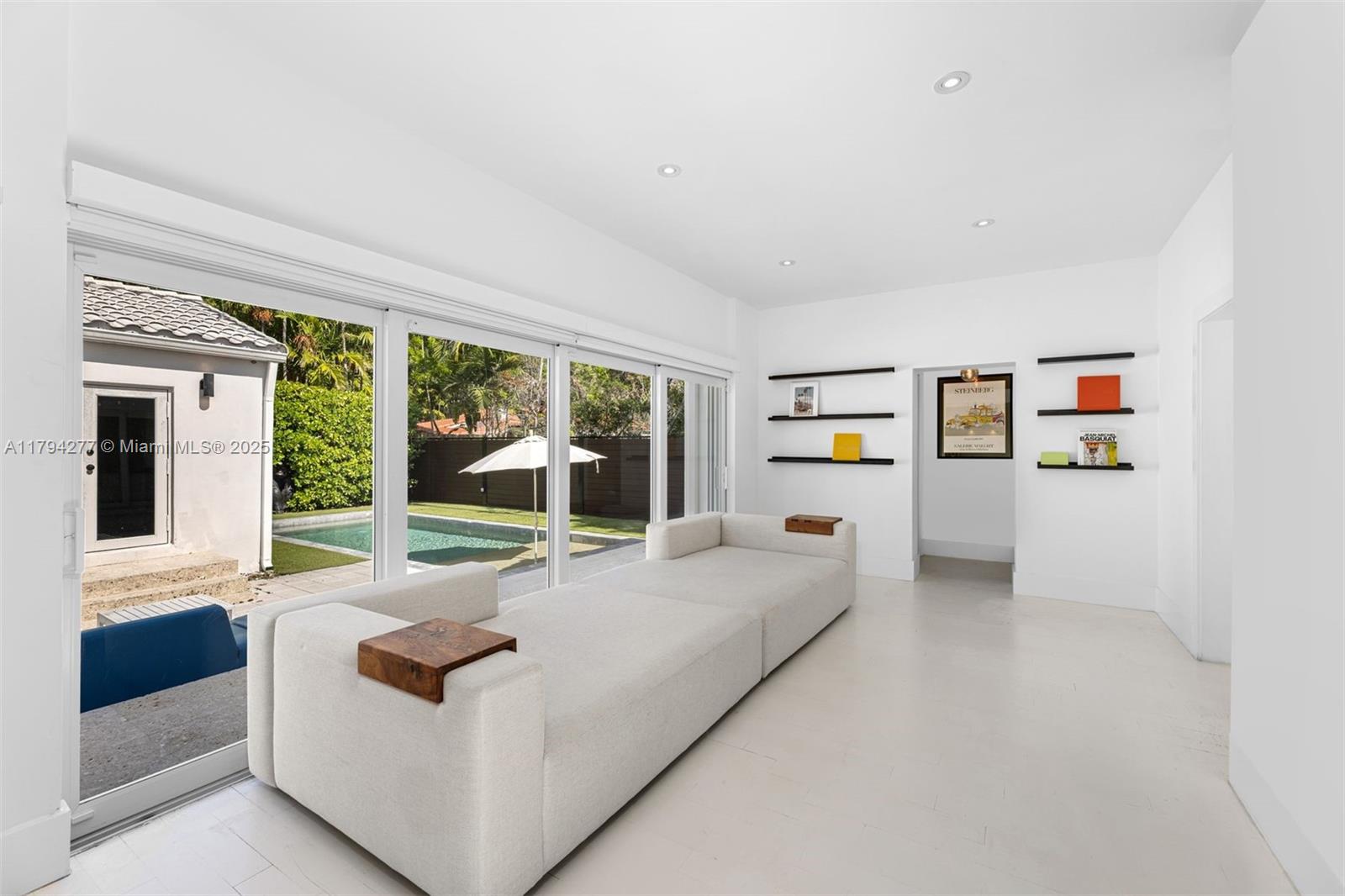 712 Northeast 72nd Street Miami, FL 33138 - Photo 23 of 35 a living room with furniture and a large window