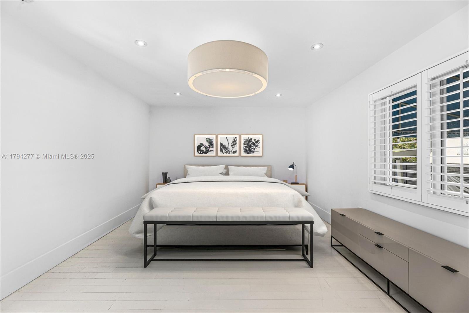 712 Northeast 72nd Street Miami, FL 33138 - Photo 24 of 35 a bed sitting in a bedroom next to a window