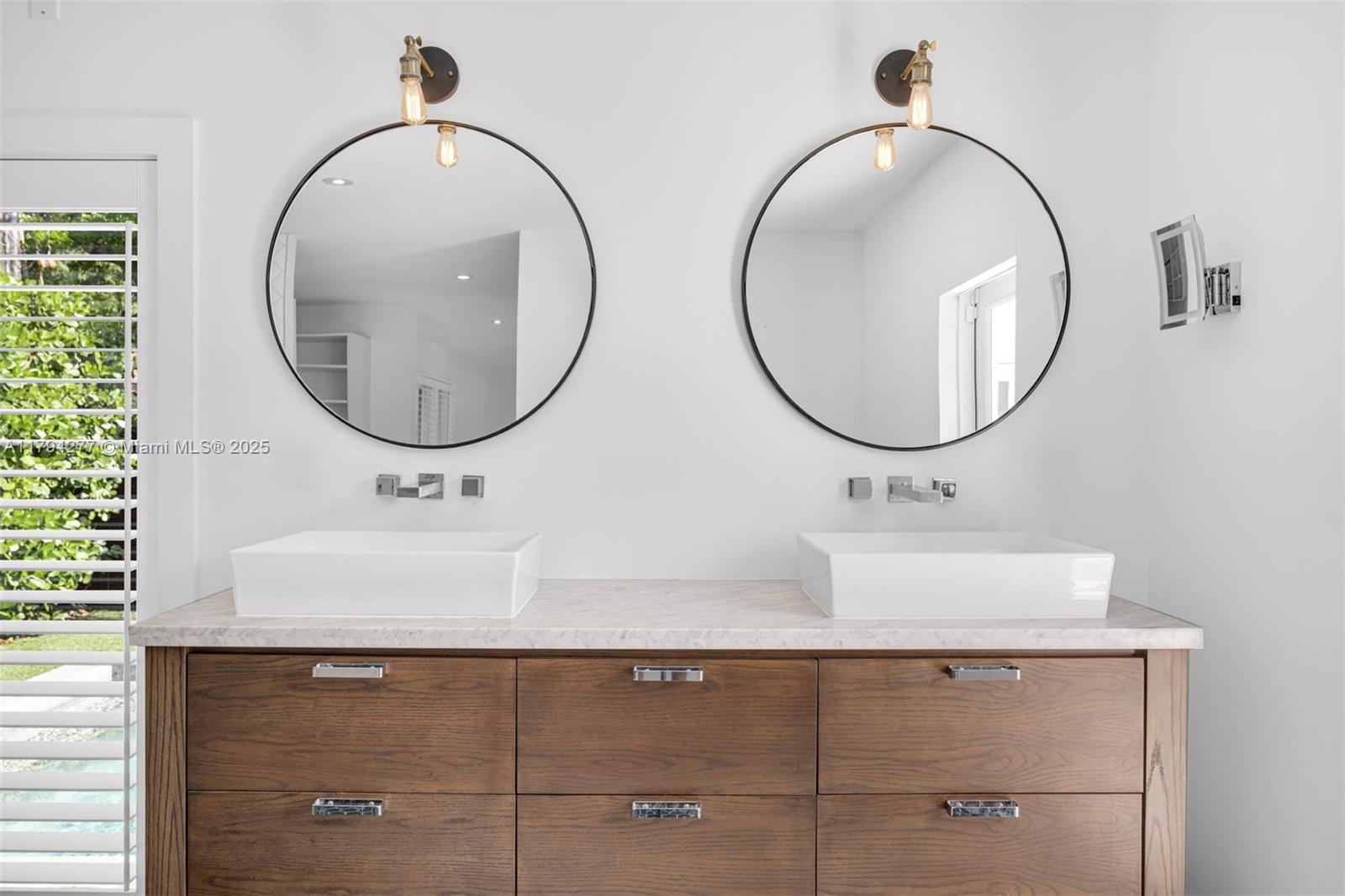 712 Northeast 72nd Street Miami, FL 33138 - Photo 26 of 35 a bathroom with a sink and a mirror