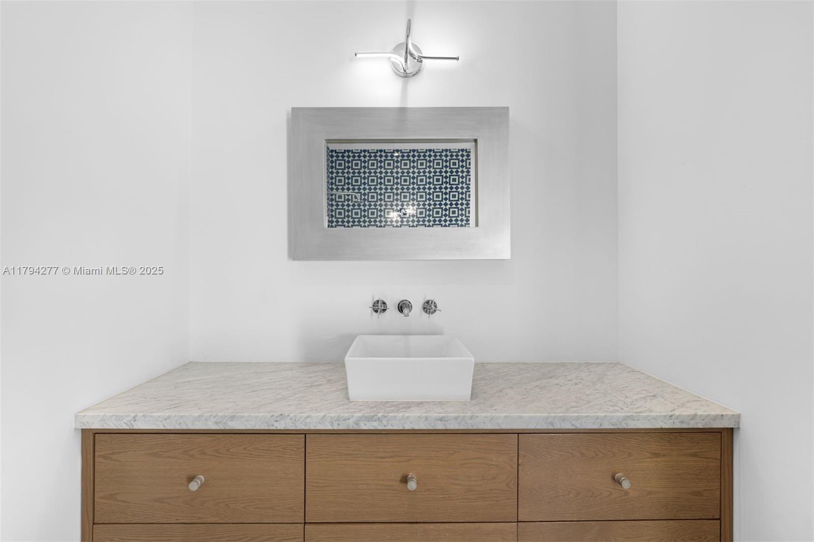 712 Northeast 72nd Street Miami, FL 33138 - Photo 31 of 35 a bathroom with a granite countertop sink and vanity