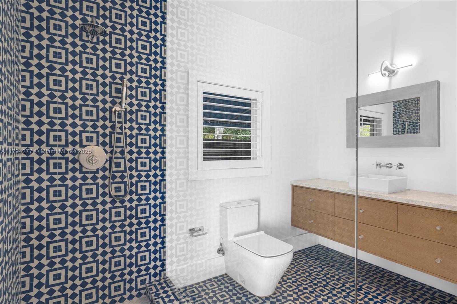 712 Northeast 72nd Street Miami, FL 33138 - Photo 32 of 35 a bathroom with a sink toilet a mirror and shower