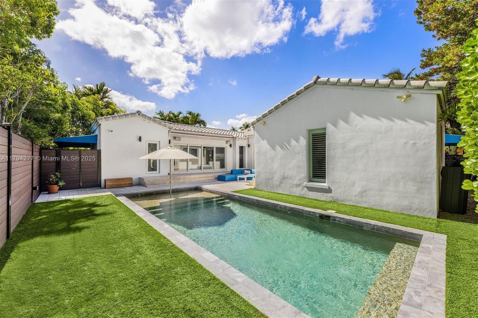 712 Northeast 72nd Street Miami, FL 33138 - Photo 34 of 35 a view of a house with a swimming pool
