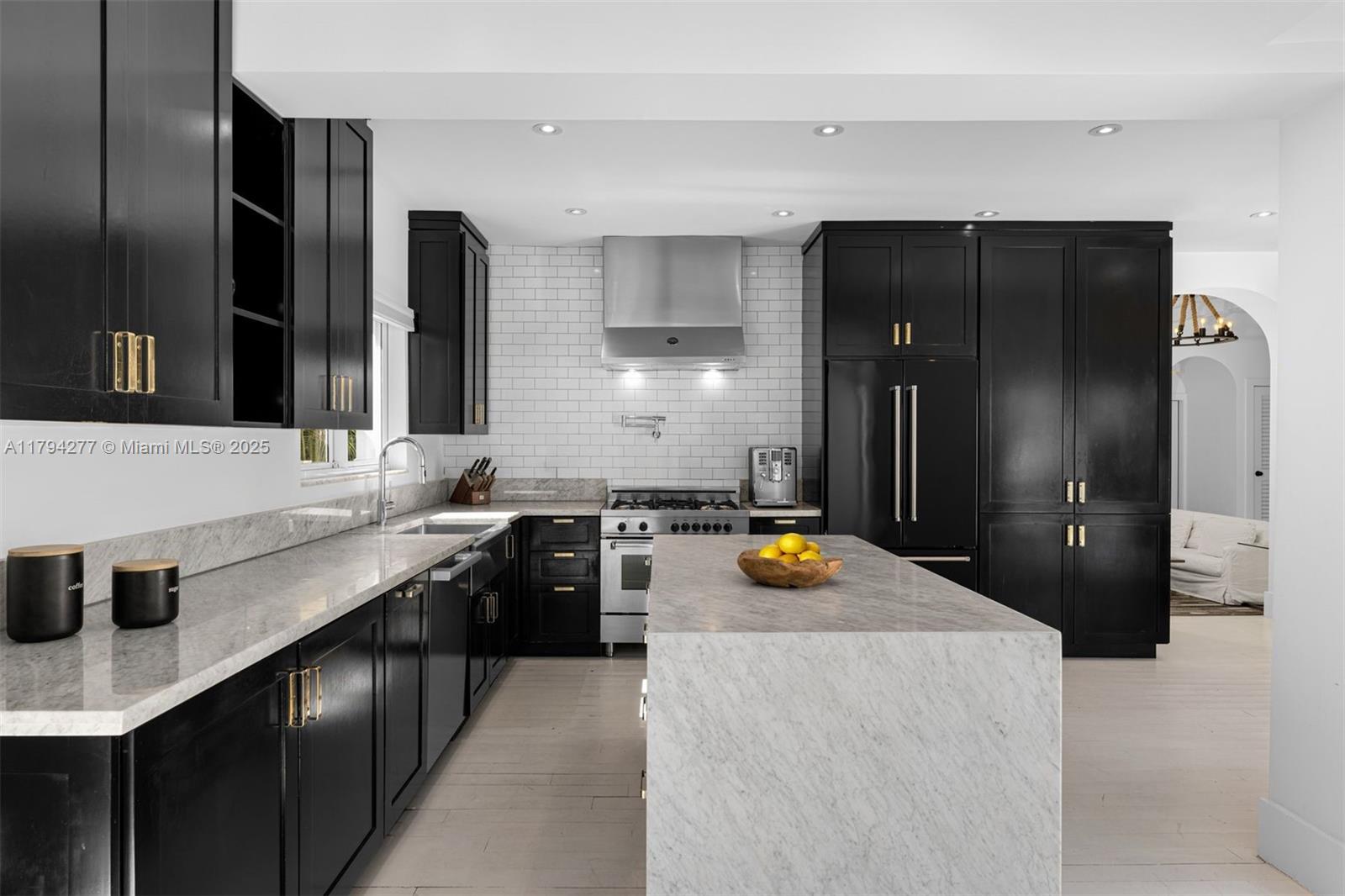 712 Northeast 72nd Street Miami, FL 33138 - Photo 5 of 35 a kitchen with a sink a stove and refrigerator