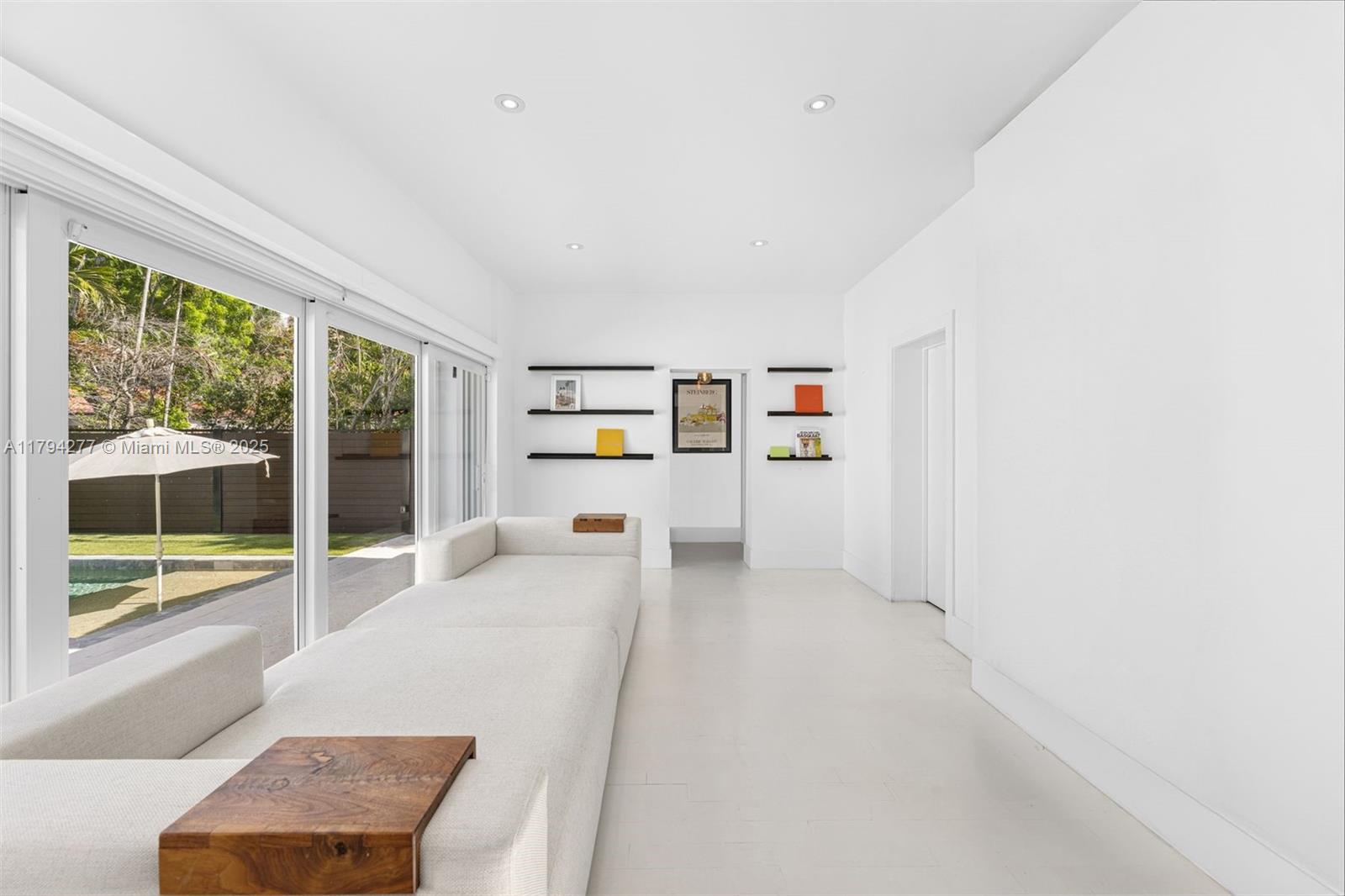 712 Northeast 72nd Street Miami, FL 33138 - Photo 7 of 35 a living room with furniture and a large window