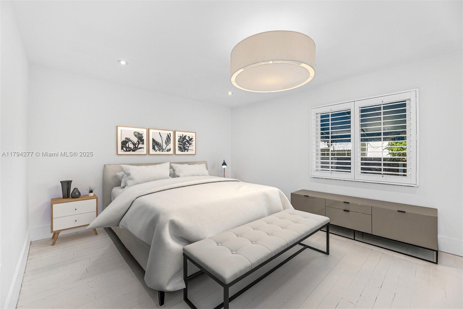 712 Northeast 72nd Street Miami, FL 33138 - Photo 8 of 35 a bedroom with a bed and a window