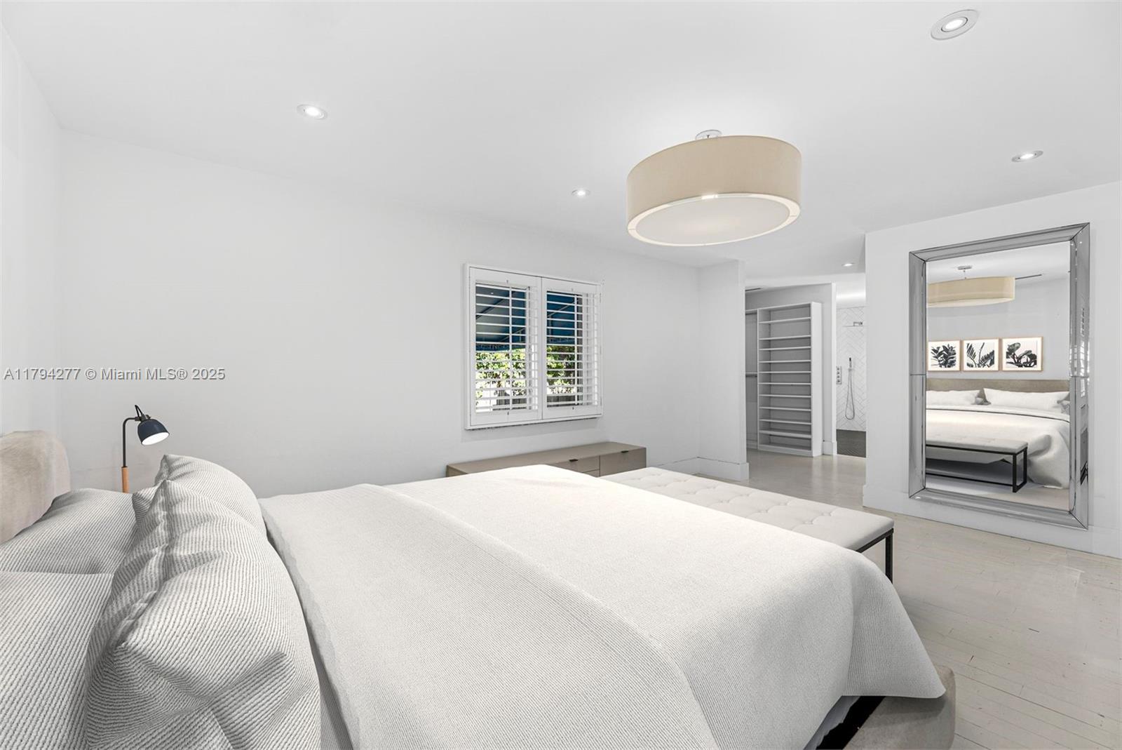 712 Northeast 72nd Street Miami, FL 33138 - Photo 9 of 35 a bedroom with a bed and a chandelier