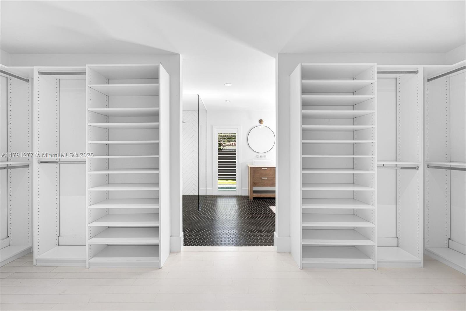 712 Northeast 72nd Street Miami, FL 33138 - Photo 10 of 35 a view of walk in closet with empty racks