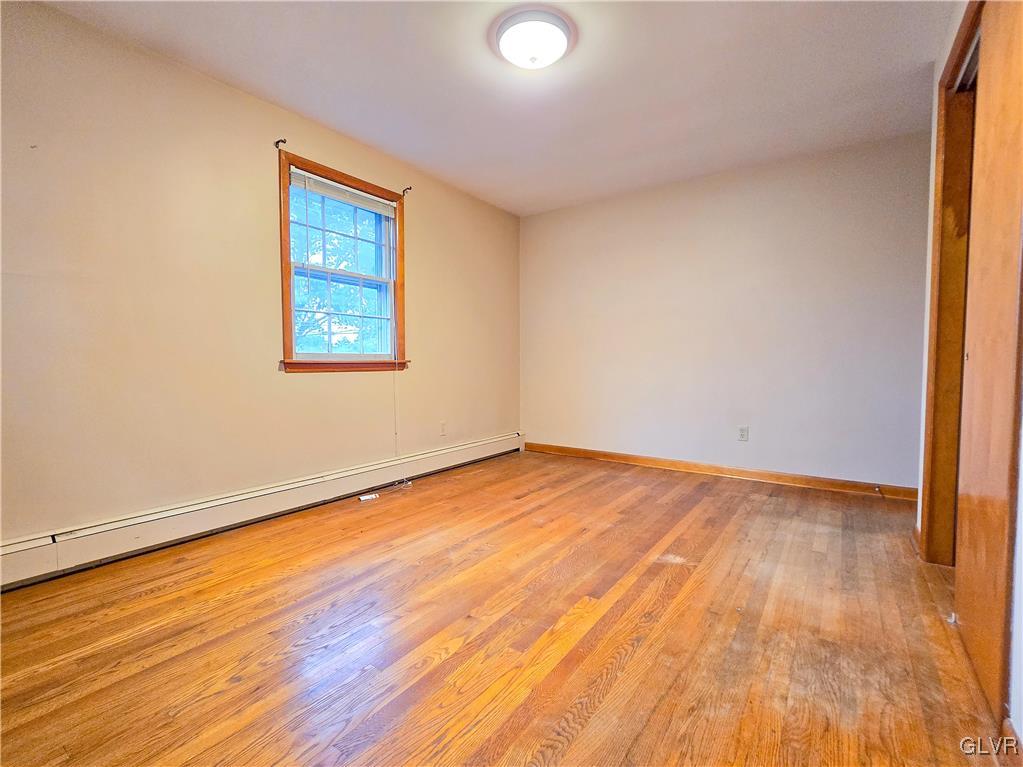 407 Cherry Hill Road Nazareth, PA 18064 - Photo 18 of 45 an empty room with wooden floor and windows