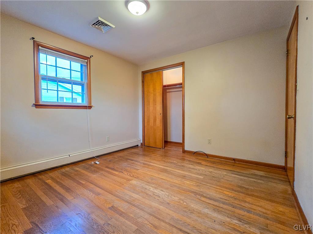 407 Cherry Hill Road Nazareth, PA 18064 - Photo 21 of 45 an empty room with wooden floor and windows
