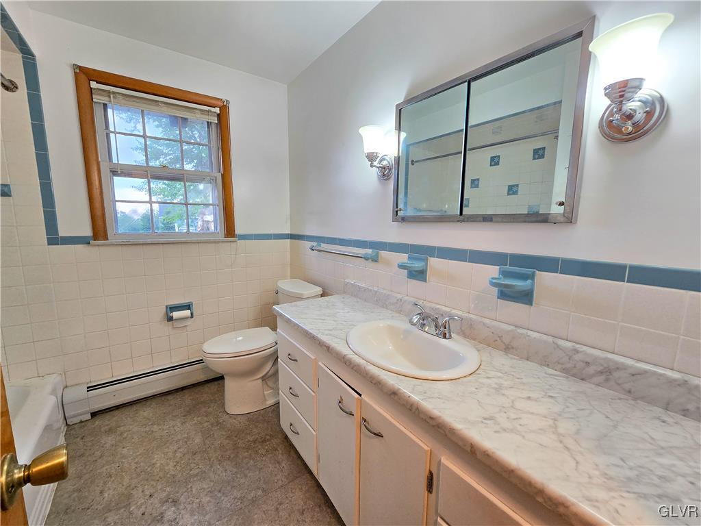 407 Cherry Hill Road Nazareth, PA 18064 - Photo 33 of 45 a bathroom with a granite countertop sink a toilet and a mirror