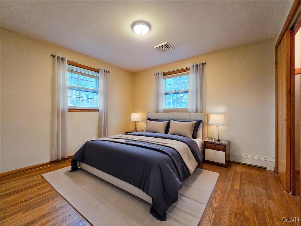 407 Cherry Hill Road Nazareth, PA 18064 - Photo 10 of 45 a bedroom with a bed and wooden floor