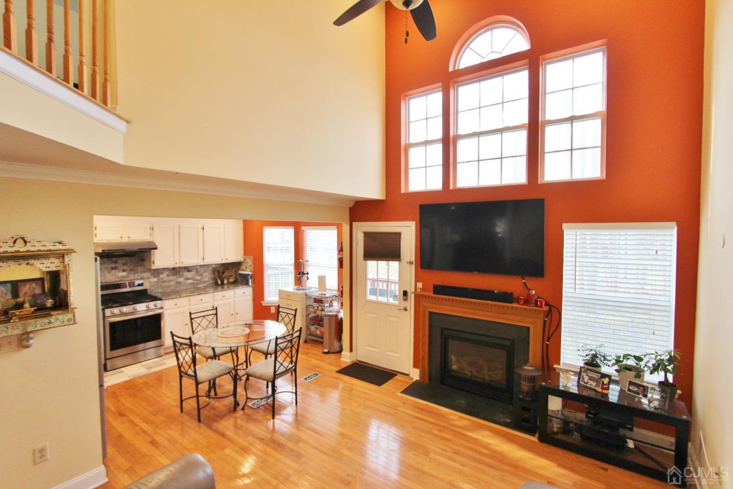 323 Hawthorne Road North Brunswick, NJ 08902 - Photo 13 of 29 a living room with furniture a fireplace and a flat screen tv