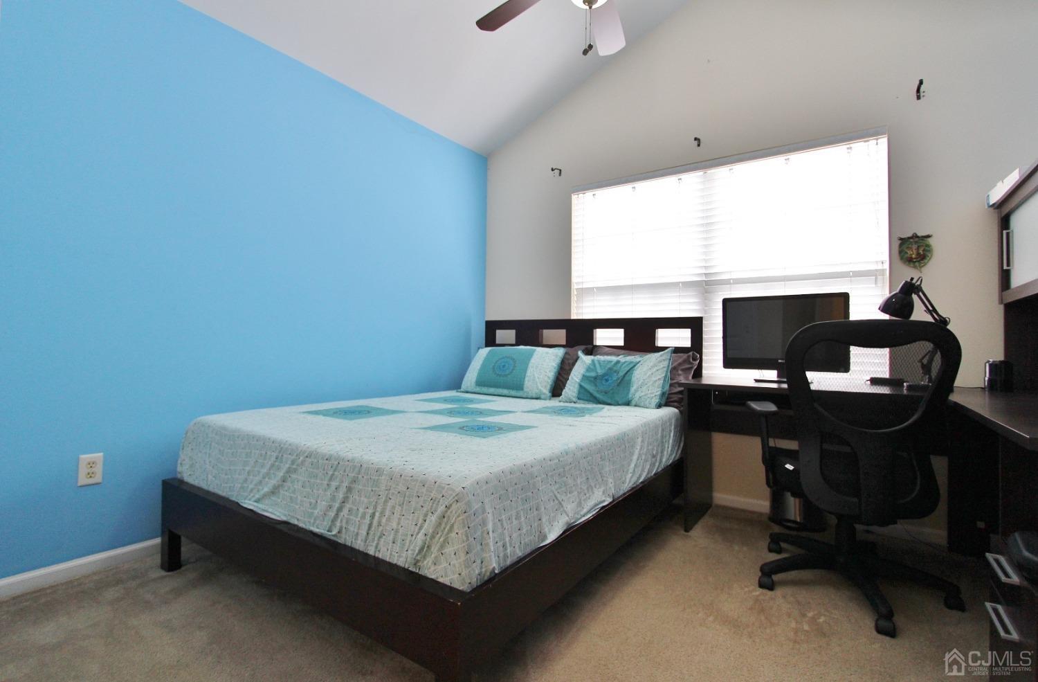 323 Hawthorne Road North Brunswick, NJ 08902 - Photo 20 of 29 a bedroom with a bed table chair and a window
