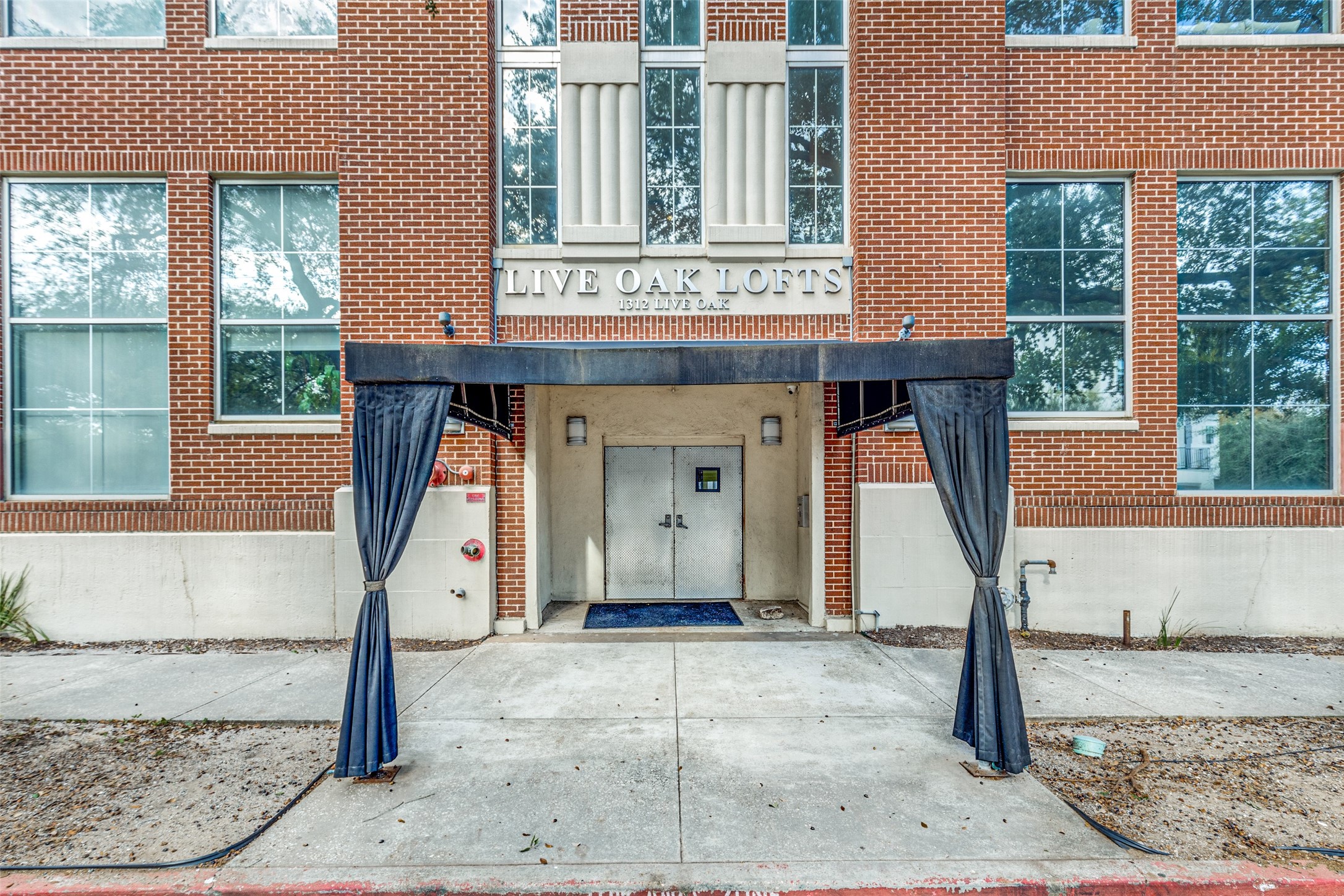 1312 Live Oak Street, Unit 223 Houston, TX 77003 - Photo 2 of 25 a front view of a house with garden