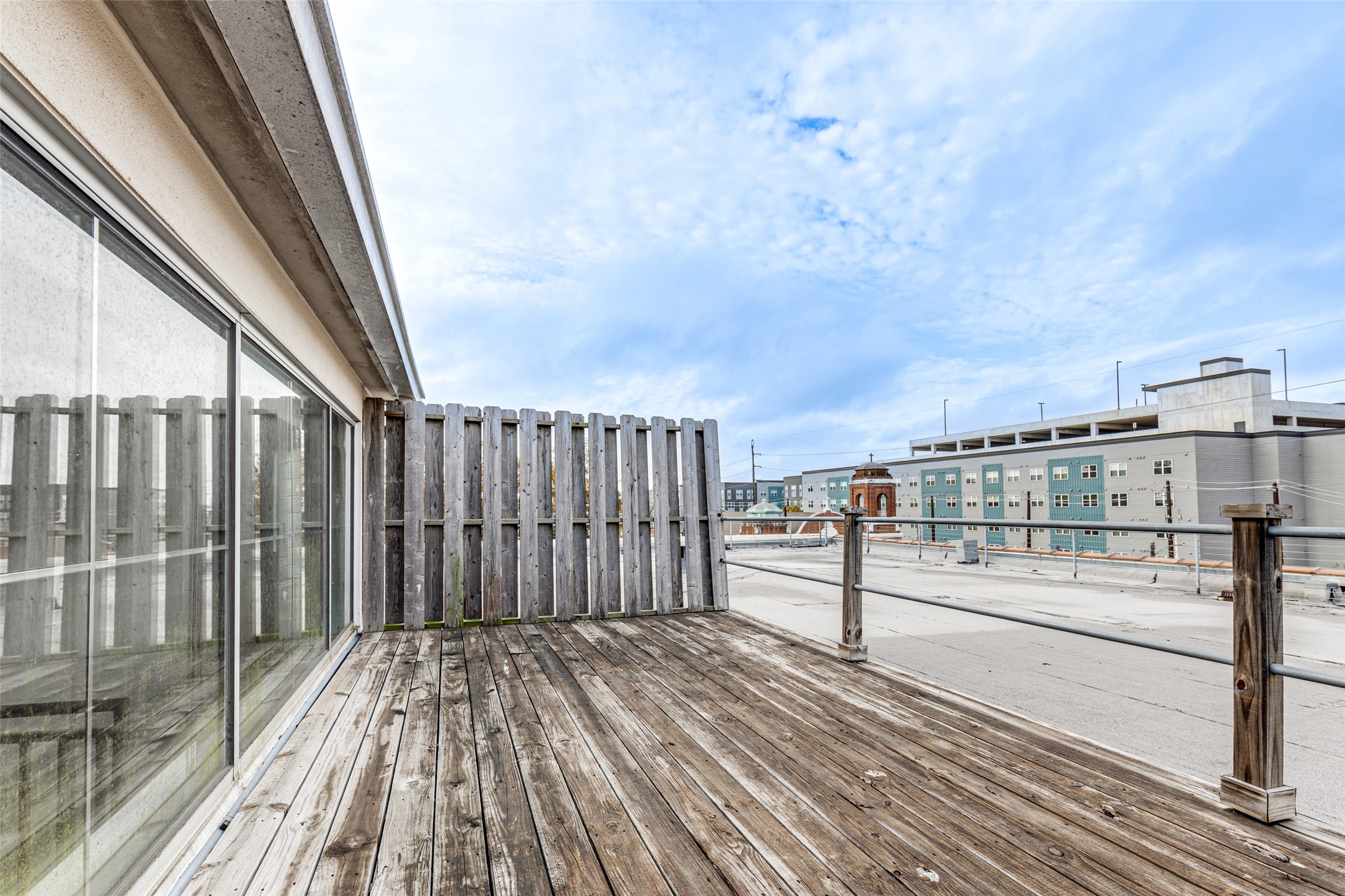 1312 Live Oak Street, Unit 223 Houston, TX 77003 - Photo 22 of 25 a view of a balcony with wooden floor and fence