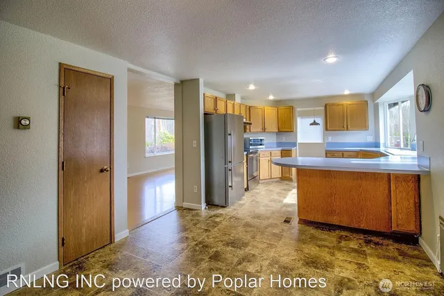 a view of kitchen with refrigerator cabinets and outdoor seating