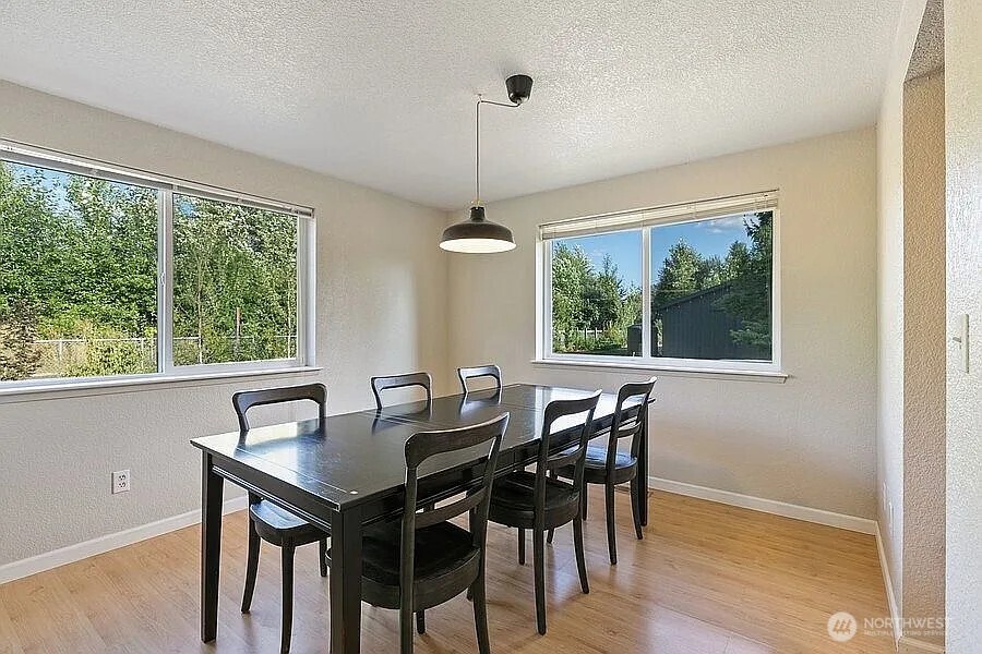 Undisclosed Address Redmond, WA 98052 - Photo 12 of 31 a view of a dining room with furniture window and outside view