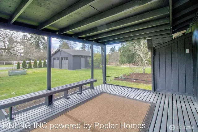 a view of porch with a big yard