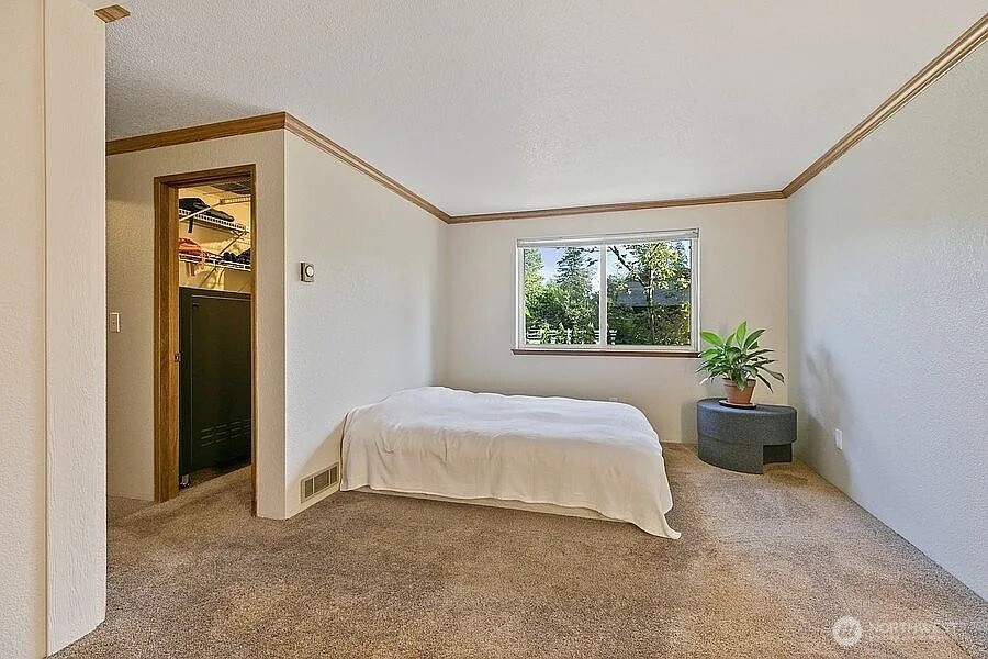 Undisclosed Address Redmond, WA 98052 - Photo 18 of 31 a bedroom with a bed and a window