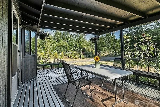 a view of balcony with furniture and wooden floor