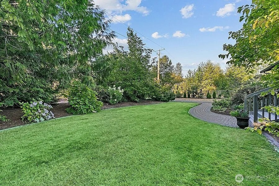 Undisclosed Address Redmond, WA 98052 - Photo 28 of 31 a view of a garden with a building in the background
