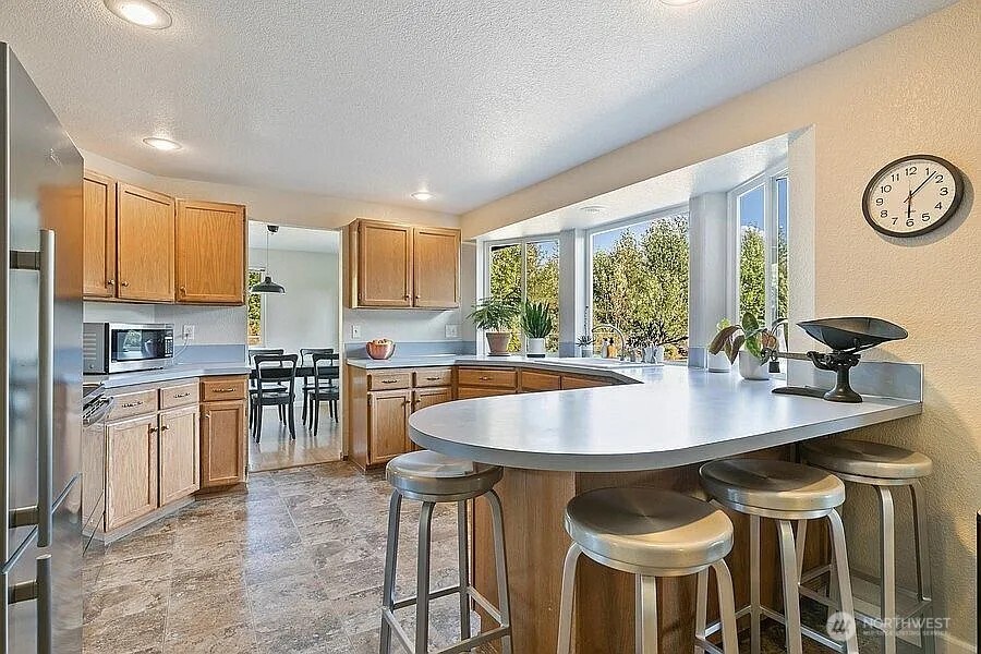 Undisclosed Address Redmond, WA 98052 - Photo 5 of 31 a kitchen with appliances a sink and cabinets
