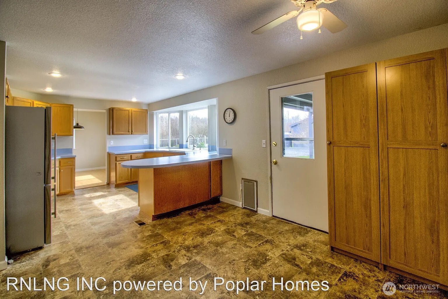 Undisclosed Address Redmond, WA 98052 - Photo 10 of 31 a view of a kitchen with a refrigerator