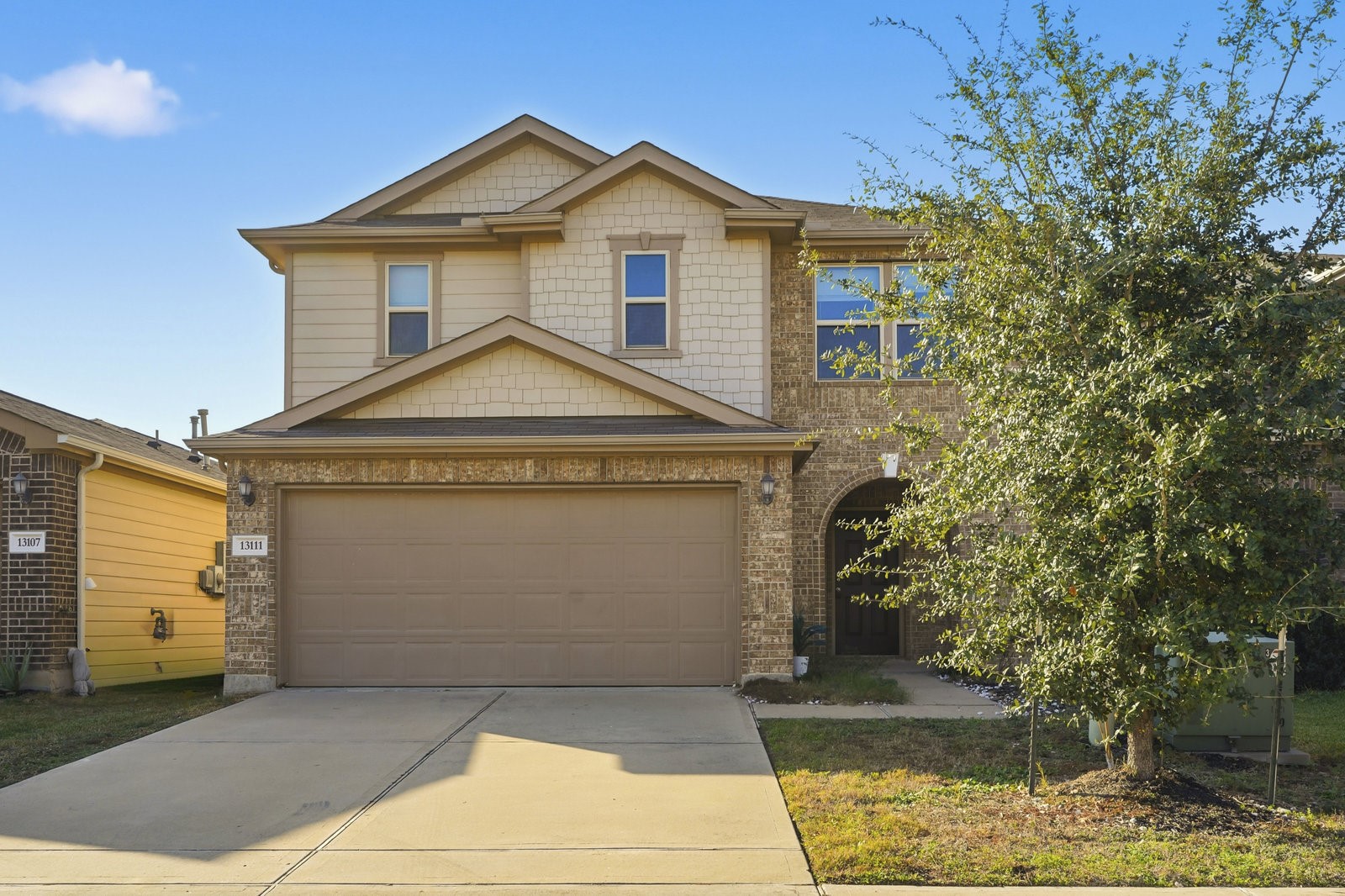 a front view of a house with a yard garage and garage